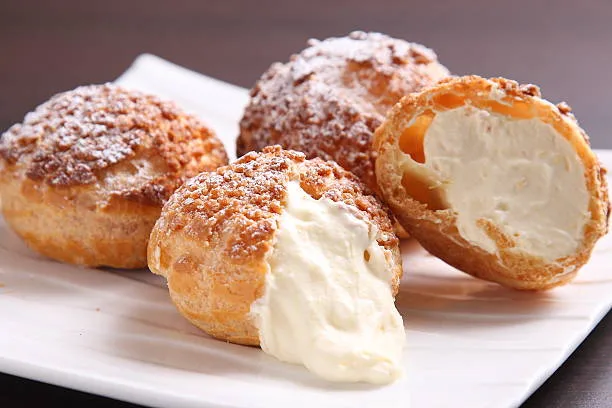 Tray of cream puffs and choux pastries